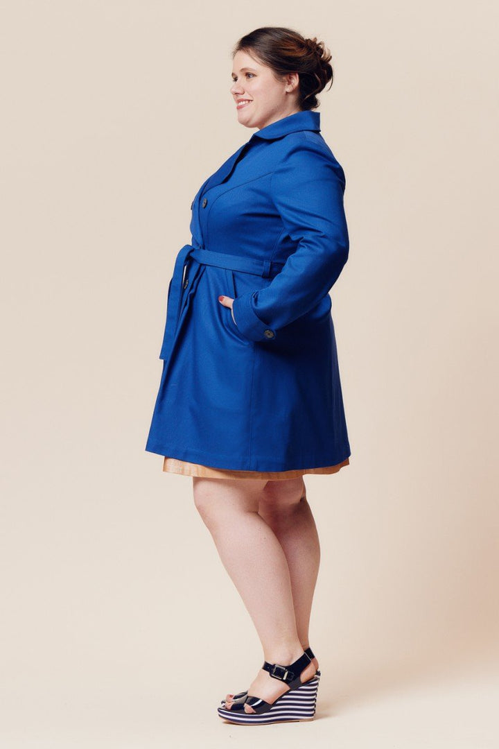 Deer and Doe Luzerne Trench Coat sewing pattern with double-breasted front, princess seams, pleats, and diagonal welt pockets, sizes 34–46