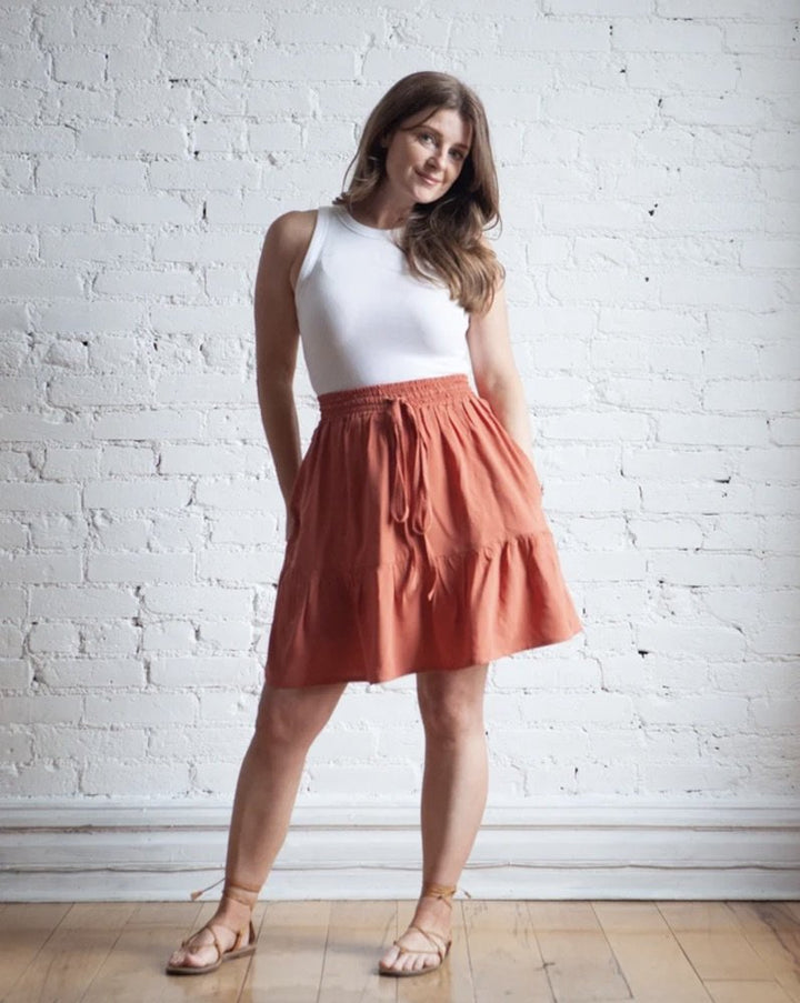 True Bias Mave Skirt sewing pattern in lightweight drapey fabric, featuring elastic waist, drawstring, inseam pockets, and optional ruffle hem in various lengths.