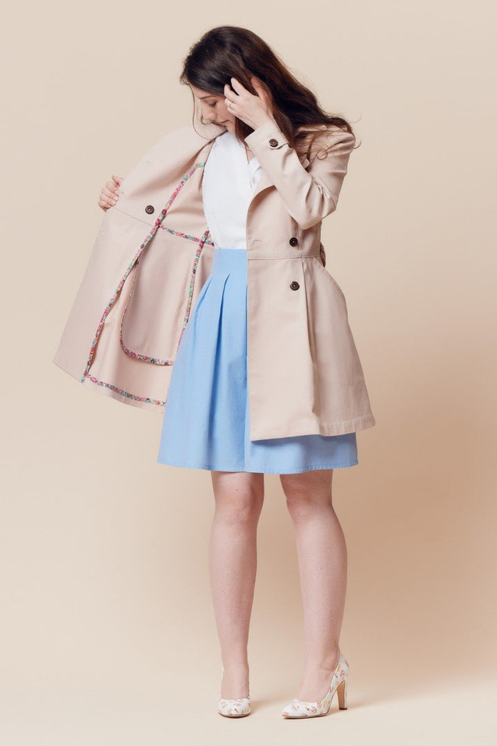 Deer and Doe Luzerne Trench Coat sewing pattern with double-breasted front, princess seams, pleats, and diagonal welt pockets, sizes 34–46