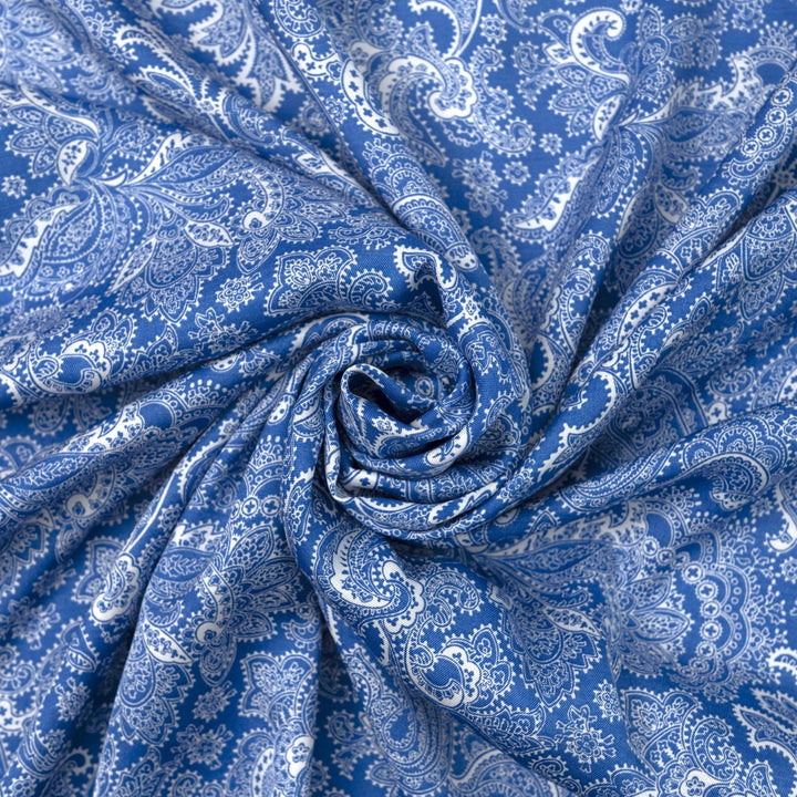 Viscose Twill fabric in cobalt blue and white paisley print, lightweight and silk-like for dressmaking
