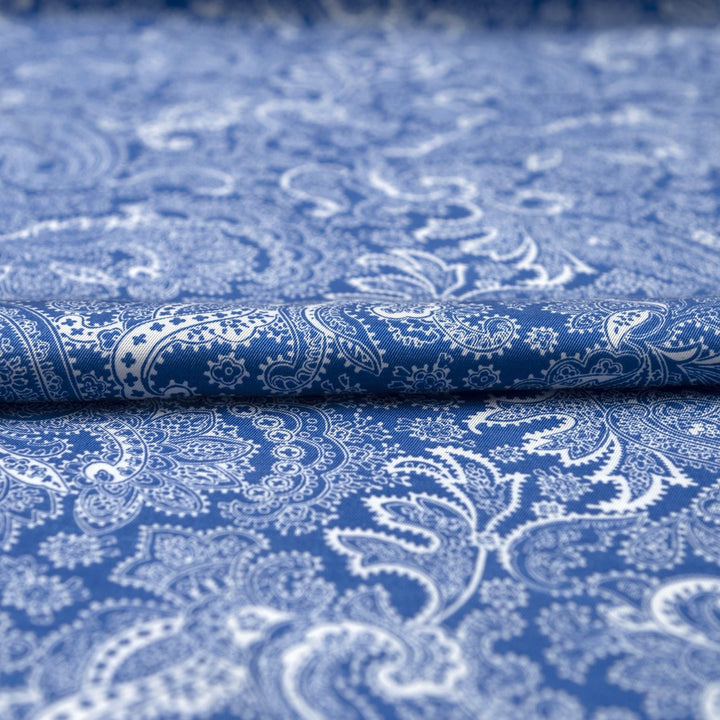 Viscose Twill fabric in cobalt blue and white paisley print, lightweight and silk-like for dressmaking