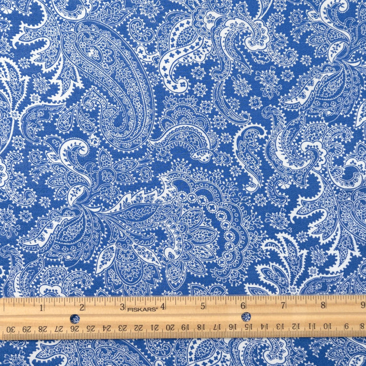Viscose Twill fabric in cobalt blue and white paisley print, lightweight and silk-like for dressmaking