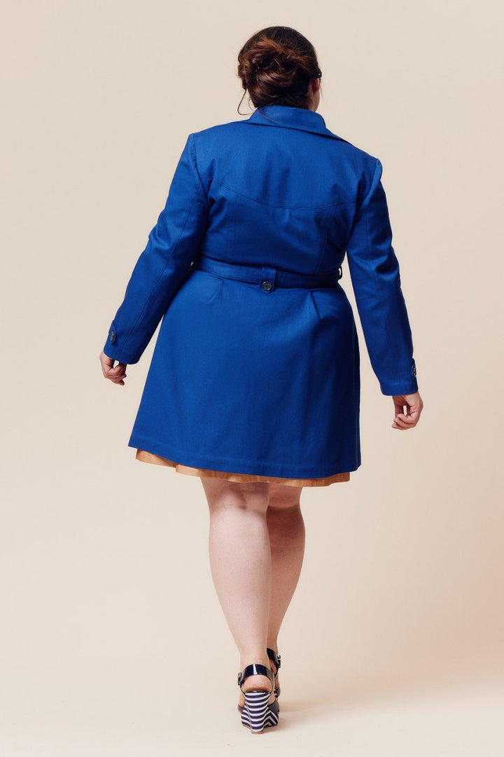 Deer and Doe Luzerne Trench Coat sewing pattern with double-breasted front, princess seams, pleats, and diagonal welt pockets, sizes 34–46