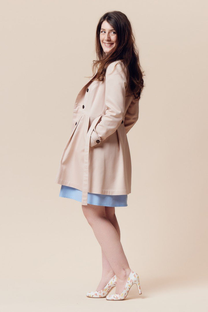 Deer and Doe Luzerne Trench Coat sewing pattern with double-breasted front, princess seams, pleats, and diagonal welt pockets, sizes 34–46