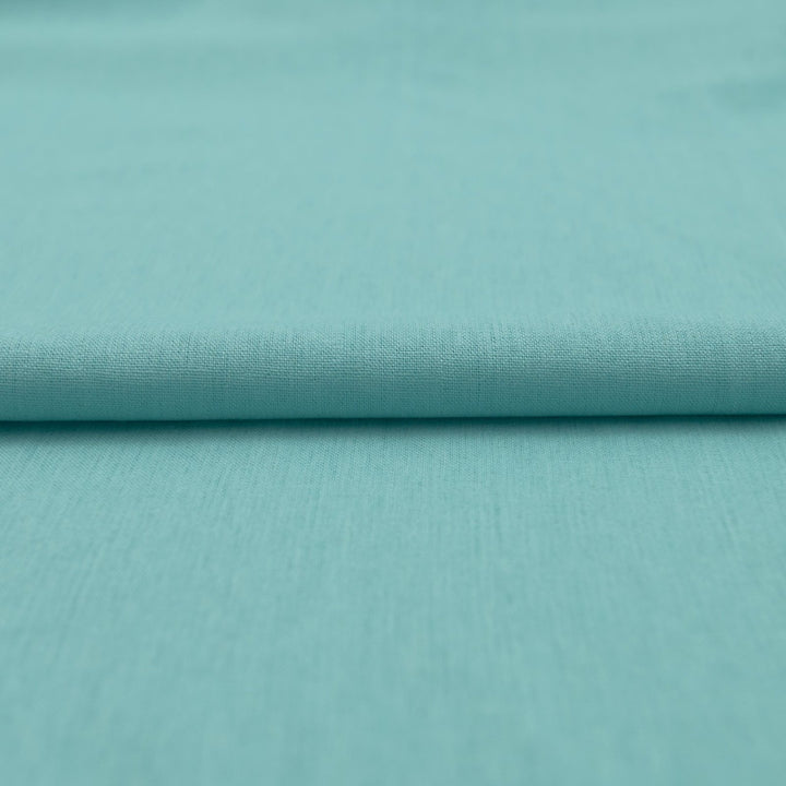 Pale jade linen and cotton blend fabric, mid-weight, soft, breathable, and opaque, ideal for sewing dresses, shirts, pants, and lightweight jackets.