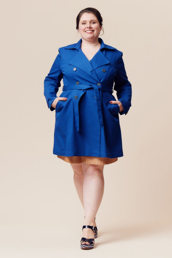 Deer and Doe Luzerne Trench Coat sewing pattern with double-breasted front, princess seams, pleats, and diagonal welt pockets, sizes 34–46