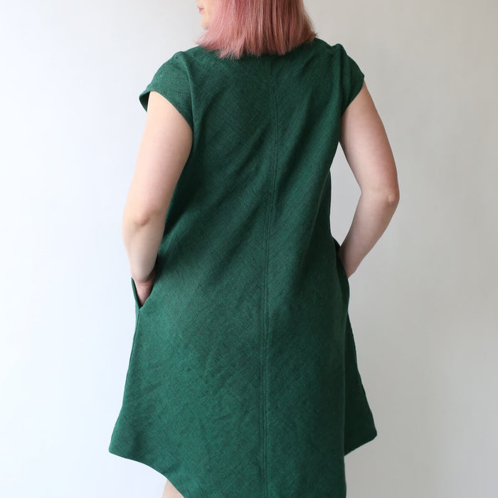 Made By Rae Emerald Dress pattern featuring a V-shaped neckline, curved hem, and optional pockets