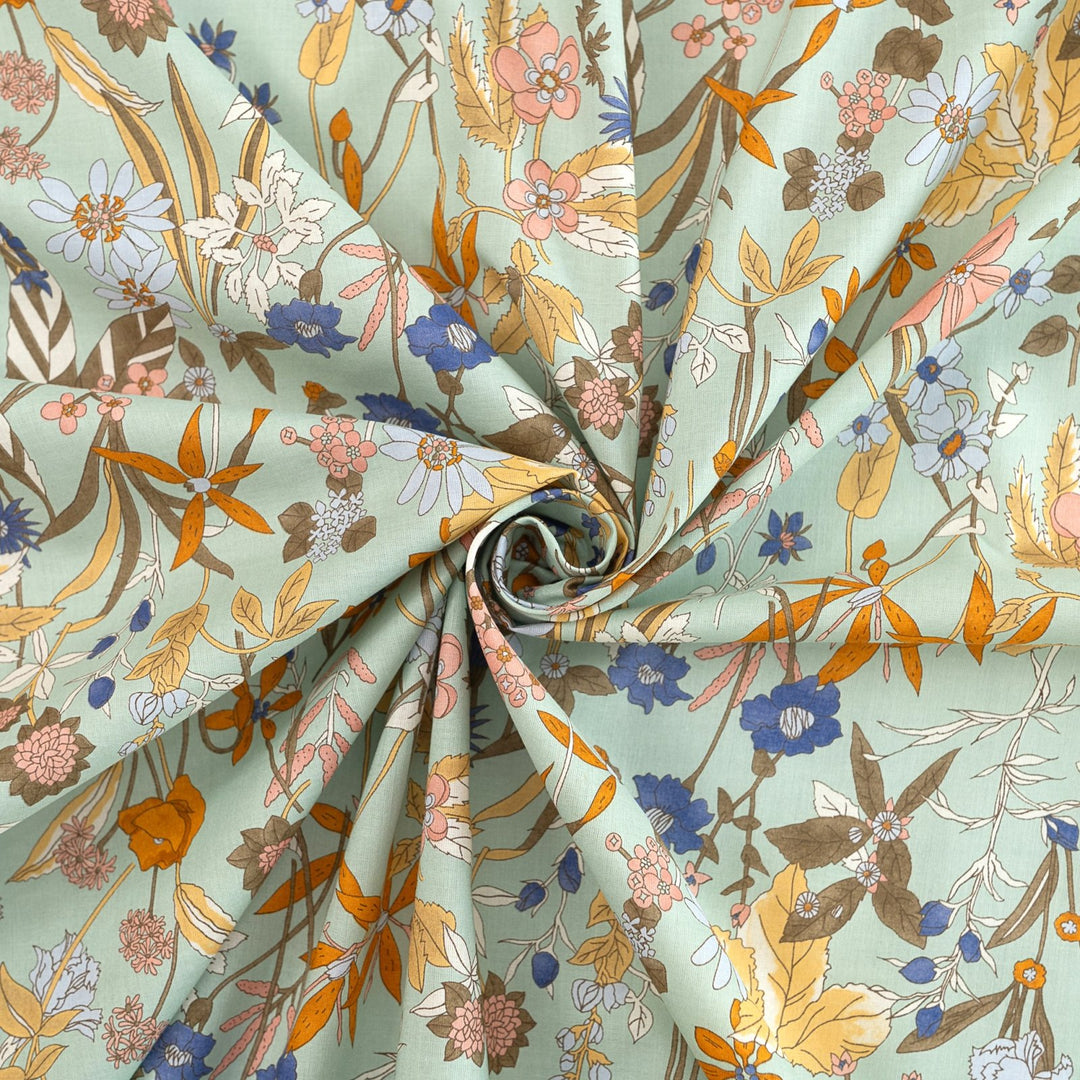 Japanese Cotton Poplin fabric by Hokkoh with green base and colorful lily floral print – soft lightweight cotton for dresses, blouses, and skirts