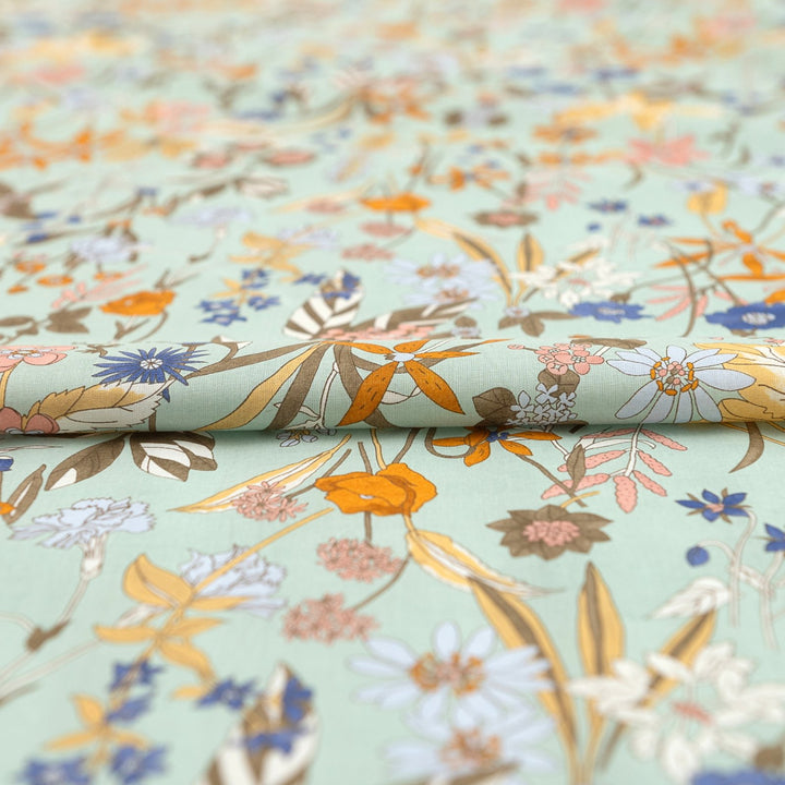 Japanese Cotton Poplin fabric by Hokkoh with green base and colorful lily floral print – soft lightweight cotton for dresses, blouses, and skirts