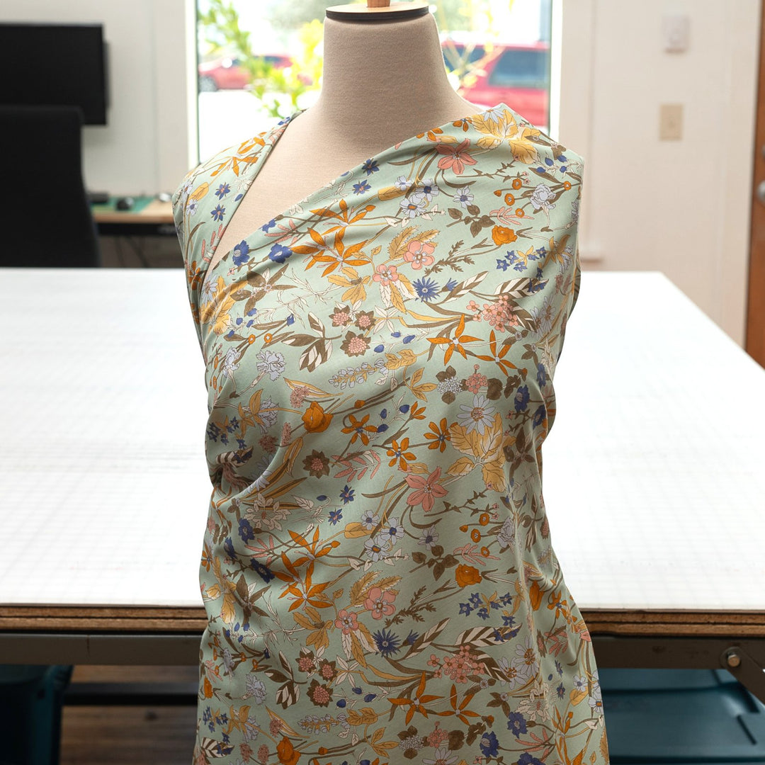 Japanese Cotton Poplin fabric by Hokkoh with green base and colorful lily floral print – soft lightweight cotton for dresses, blouses, and skirts