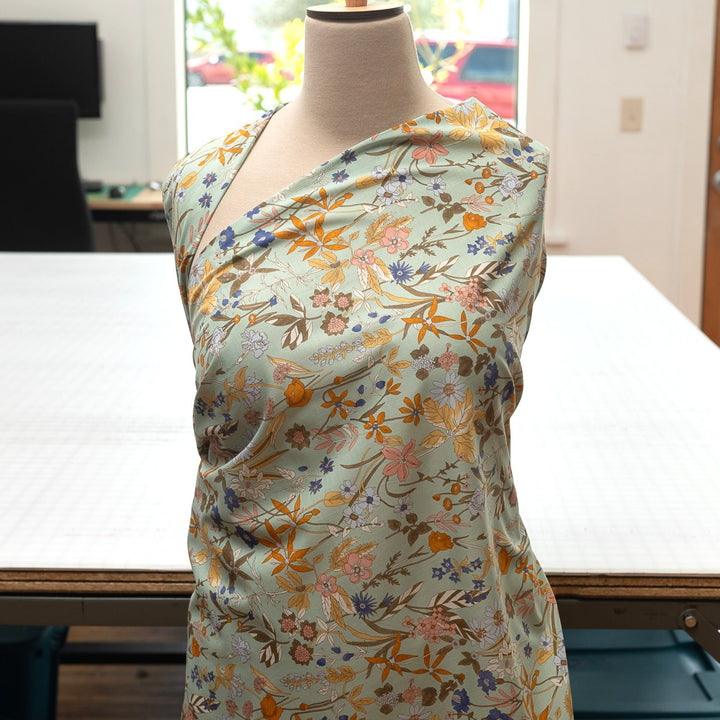 Japanese Cotton Poplin fabric by Hokkoh with green base and colorful lily floral print – soft lightweight cotton for dresses, blouses, and skirts