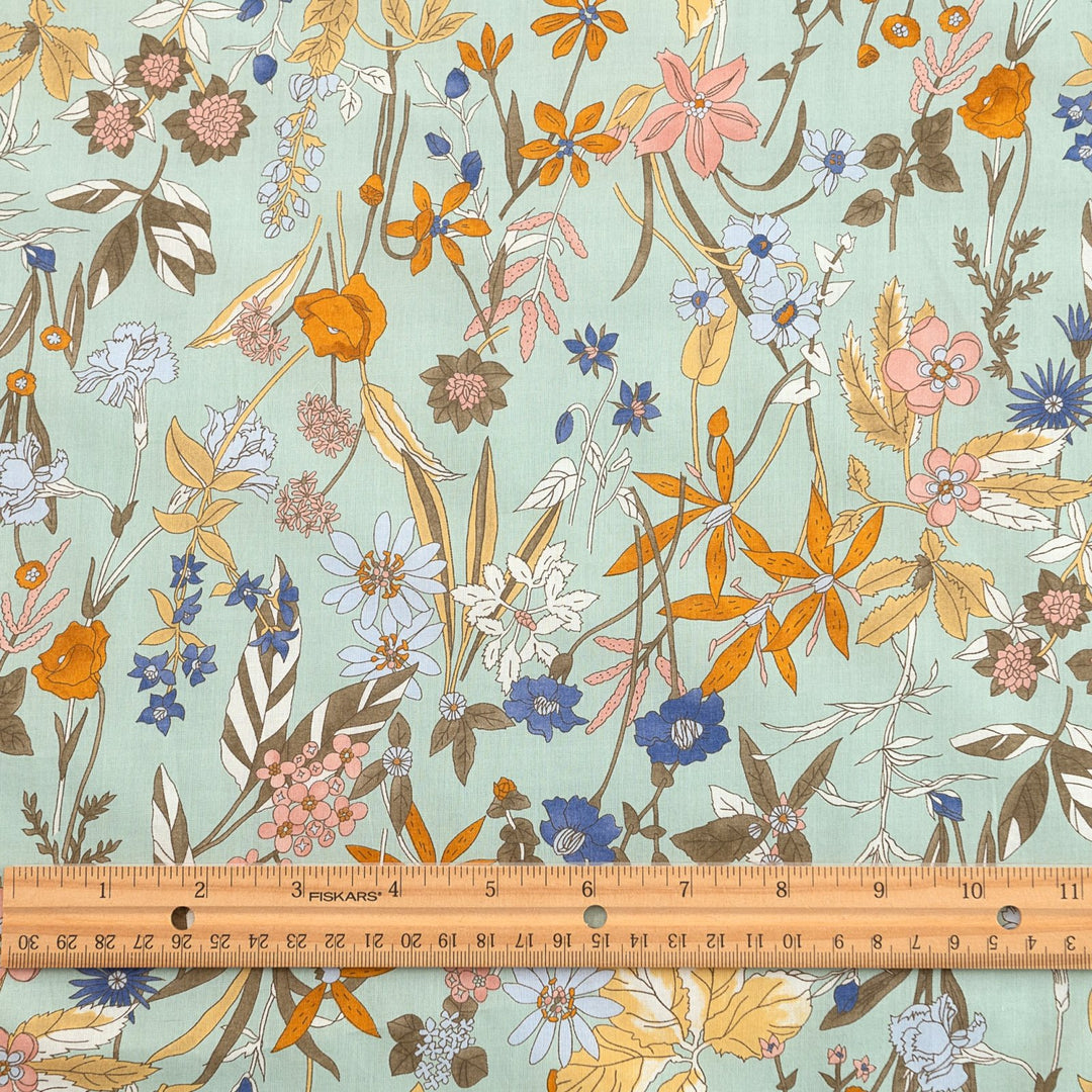 Japanese Cotton Poplin fabric by Hokkoh with green base and colorful lily floral print – soft lightweight cotton for dresses, blouses, and skirts
