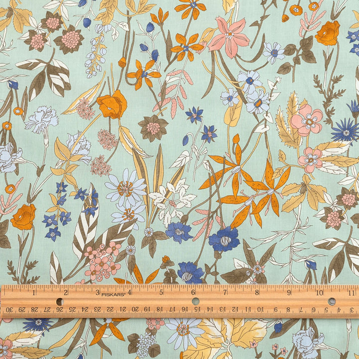 Japanese Cotton Poplin fabric by Hokkoh with green base and colorful lily floral print – soft lightweight cotton for dresses, blouses, and skirts