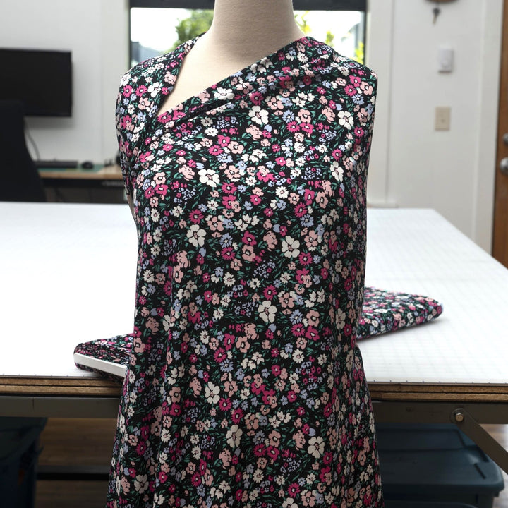 Rayon Challis fabric in Black Night Floral with pastel blooms, 54-inch wide, lightweight and flowy.
