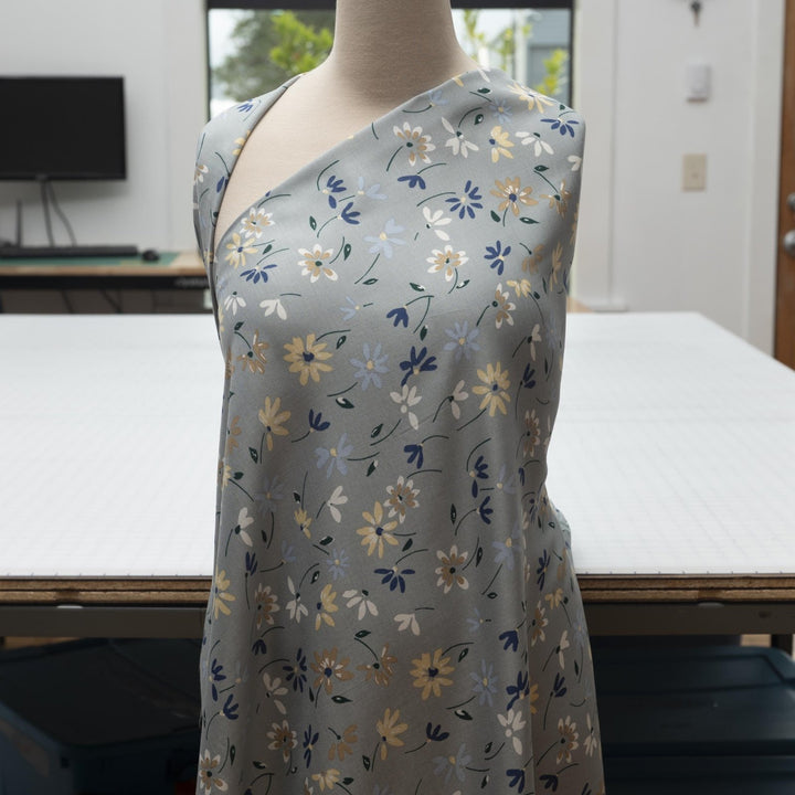Rayon Challis fabric pale blue with delicate daisy floral print, lightweight and drapey