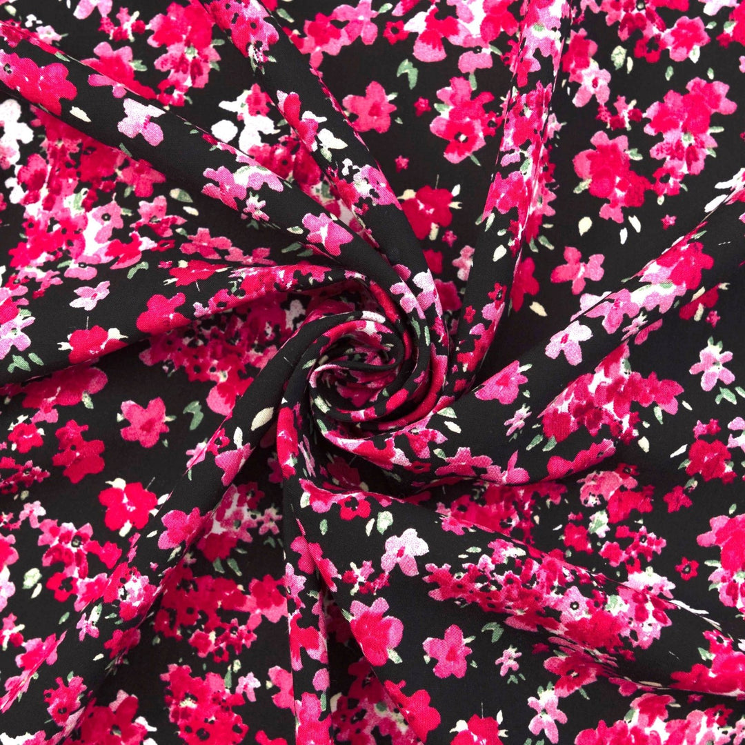 Rayon Challis Midnight Garden fabric with black base and vibrant red pink floral print, 54-inch width, lightweight woven textile