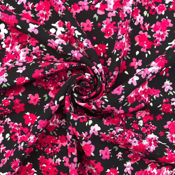 Rayon Challis Midnight Garden fabric with black base and vibrant red pink floral print, 54-inch width, lightweight woven textile