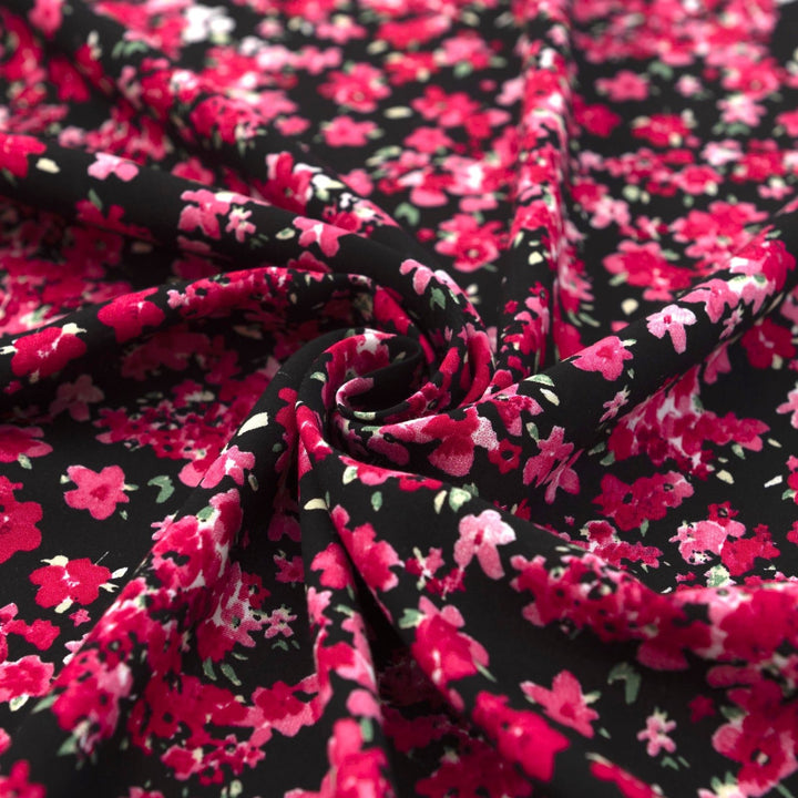 Rayon Challis Midnight Garden fabric with black base and vibrant red pink floral print, 54-inch width, lightweight woven textile