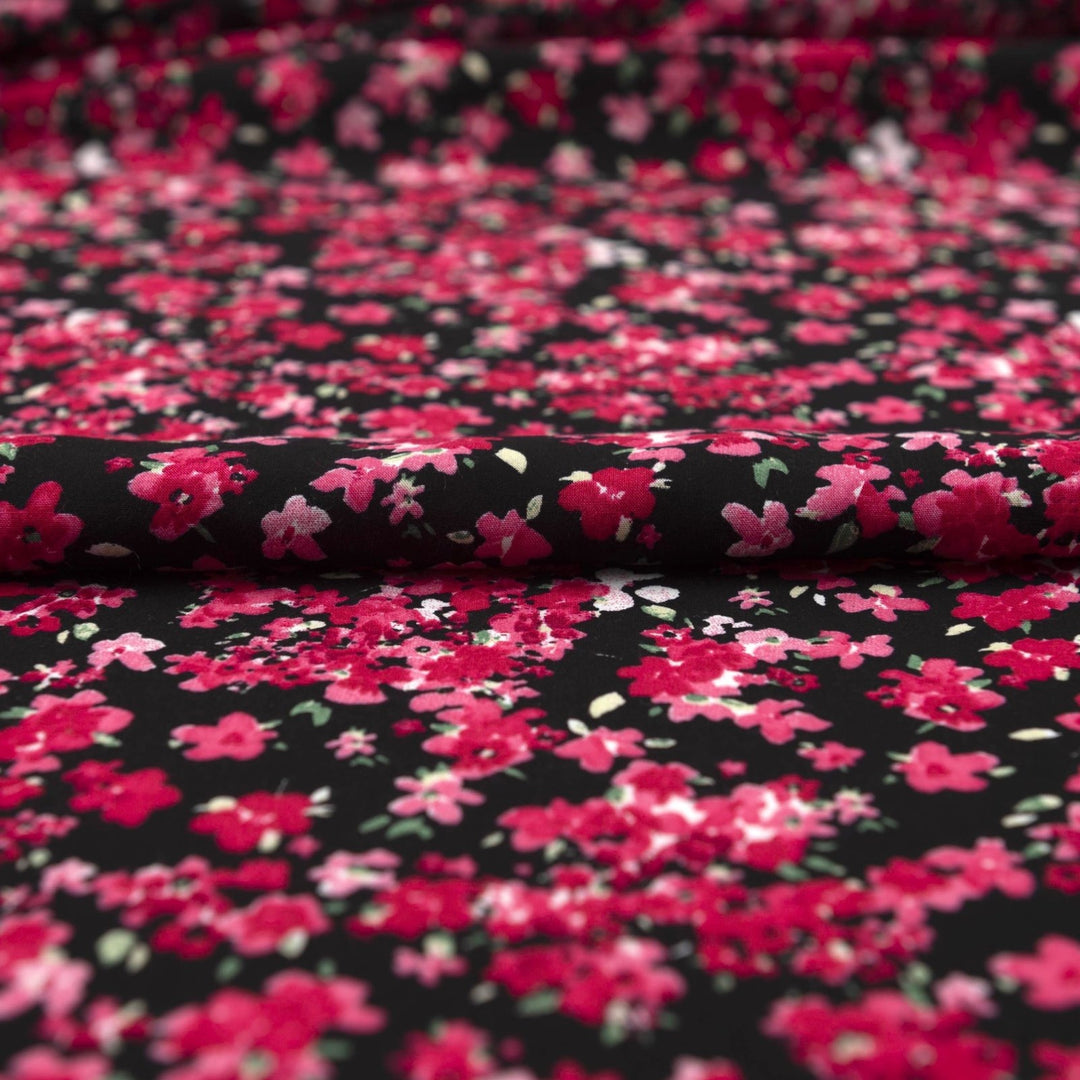 Rayon Challis Midnight Garden fabric with black base and vibrant red pink floral print, 54-inch width, lightweight woven textile