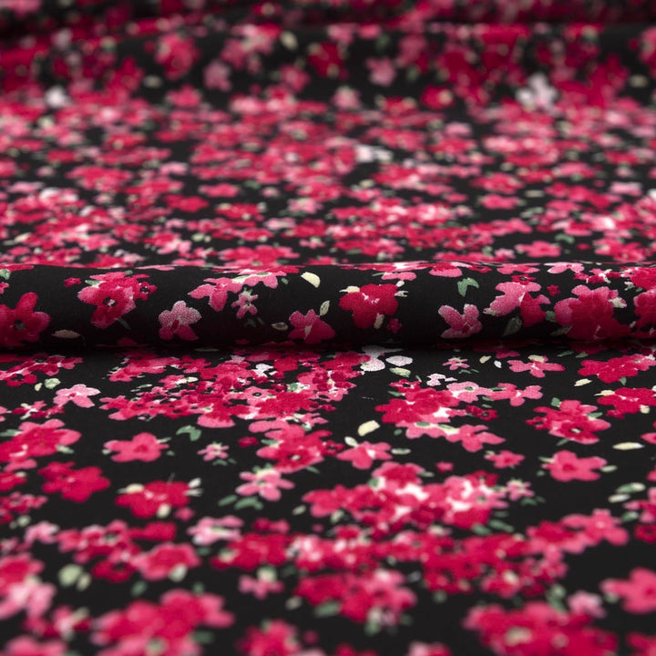 Rayon Challis Midnight Garden fabric with black base and vibrant red pink floral print, 54-inch width, lightweight woven textile