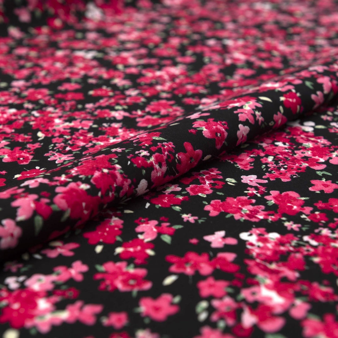 Rayon Challis Midnight Garden fabric with black base and vibrant red pink floral print, 54-inch width, lightweight woven textile