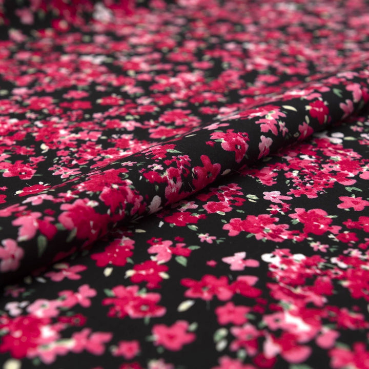 Rayon Challis Midnight Garden fabric with black base and vibrant red pink floral print, 54-inch width, lightweight woven textile