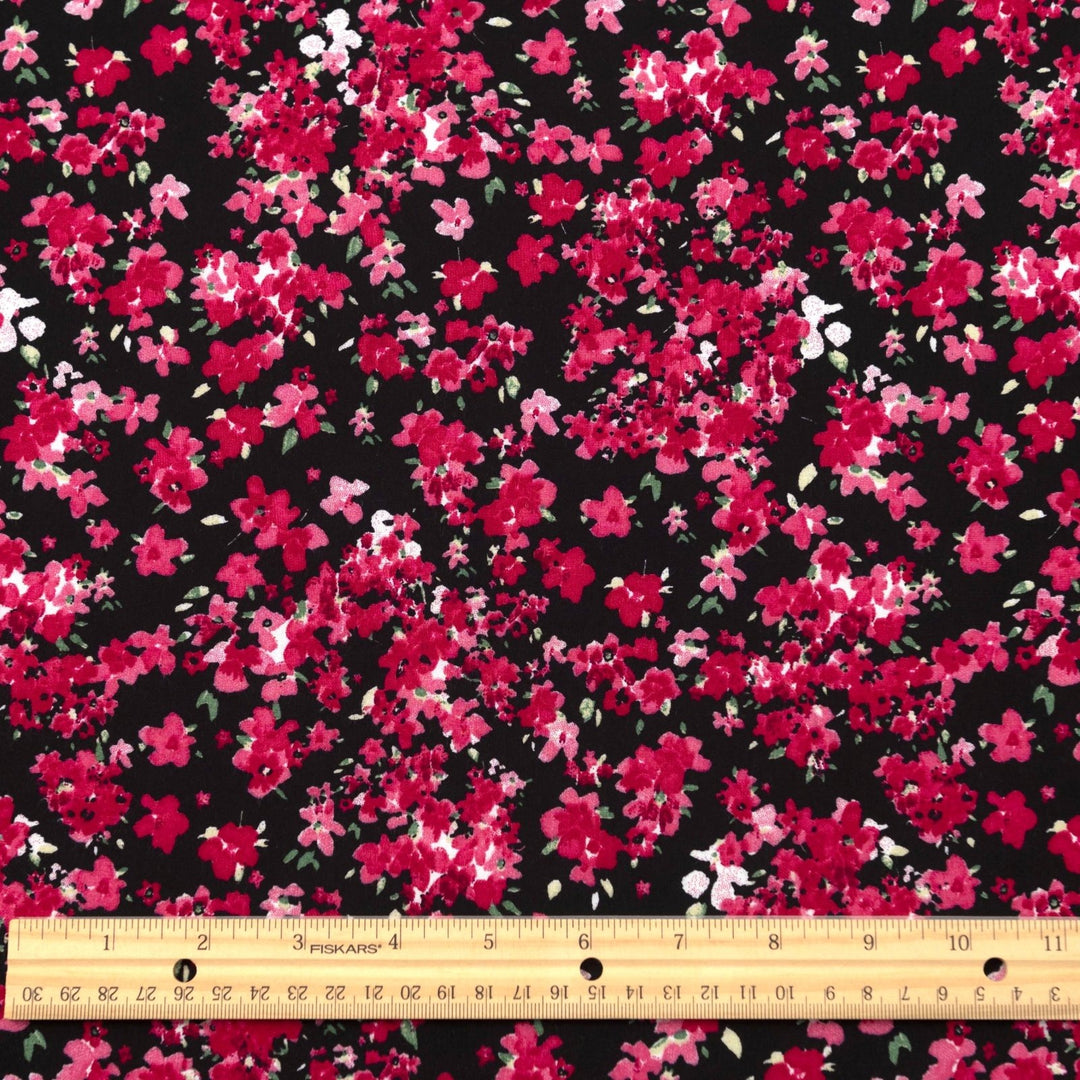 Rayon Challis Midnight Garden fabric with black base and vibrant red pink floral print, 54-inch width, lightweight woven textile