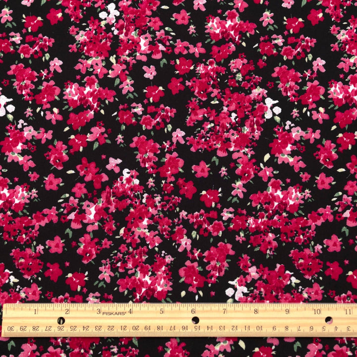 Rayon Challis Midnight Garden fabric with black base and vibrant red pink floral print, 54-inch width, lightweight woven textile