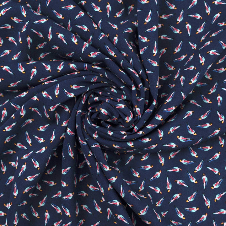 Viscose Challis fabric in navy blue with whimsical parrot print for lightweight summer dresses, skirts, and loungewear