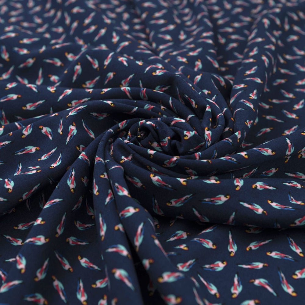 Viscose Challis fabric in navy blue with whimsical parrot print for lightweight summer dresses, skirts, and loungewear