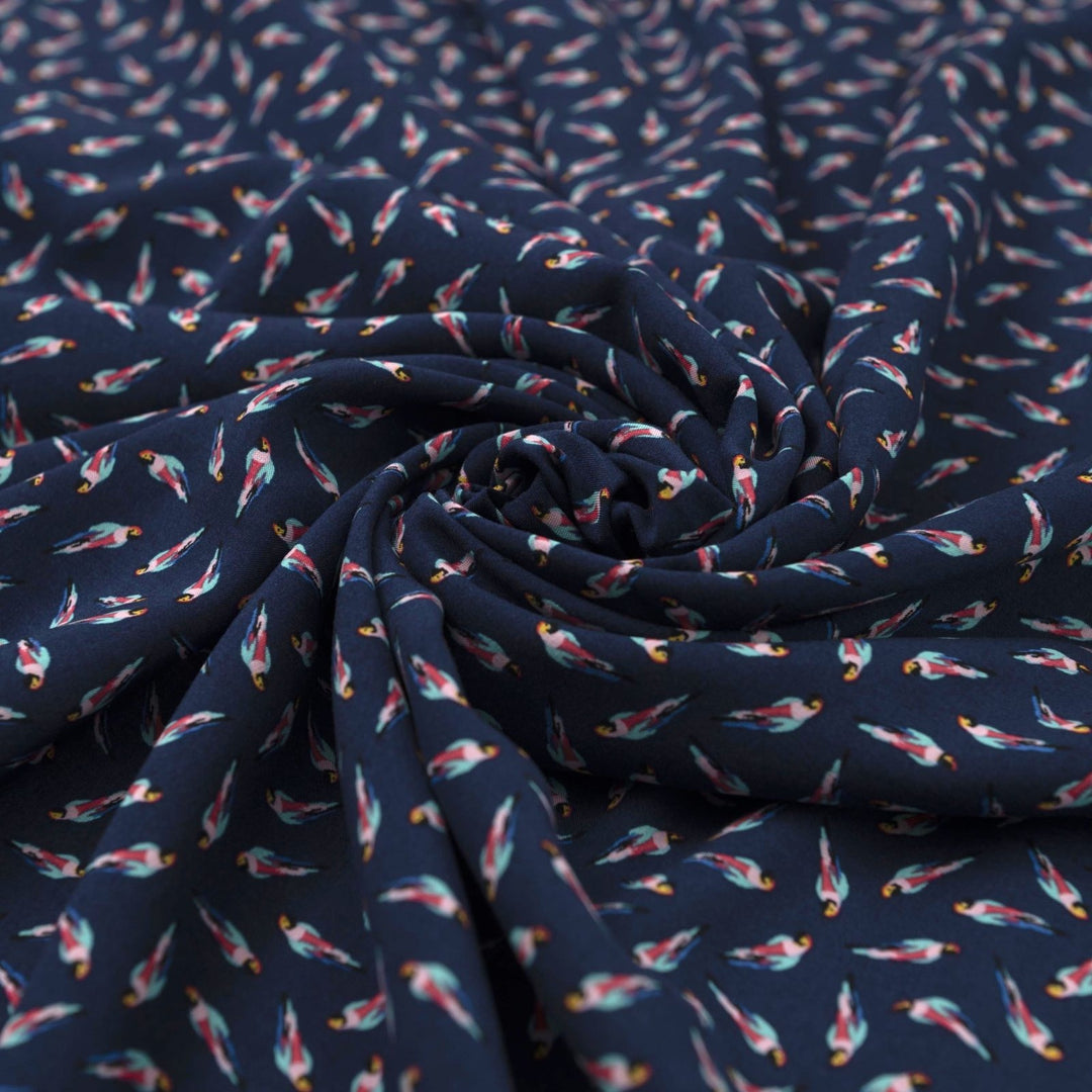 Viscose Challis fabric in navy blue with whimsical parrot print for lightweight summer dresses, skirts, and loungewear