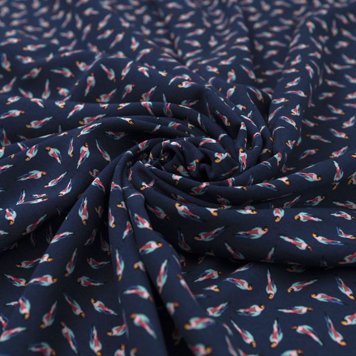 Viscose Challis fabric in navy blue with whimsical parrot print for lightweight summer dresses, skirts, and loungewear
