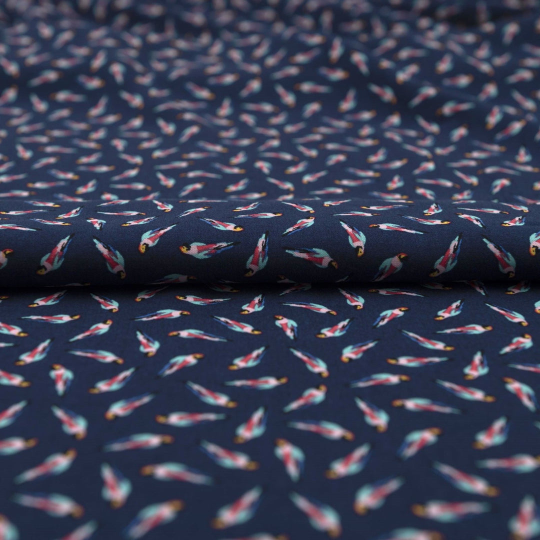 Viscose Challis fabric in navy blue with whimsical parrot print for lightweight summer dresses, skirts, and loungewear