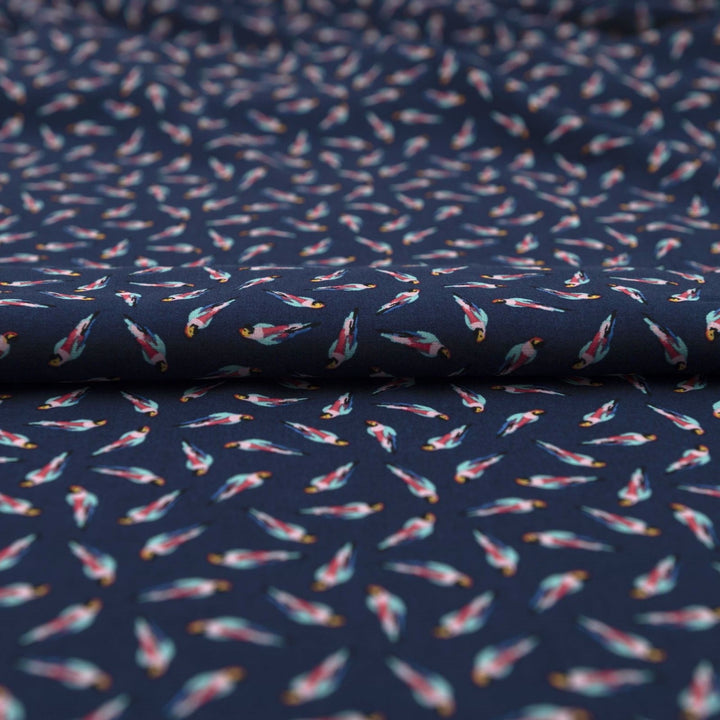 Viscose Challis fabric in navy blue with whimsical parrot print for lightweight summer dresses, skirts, and loungewear