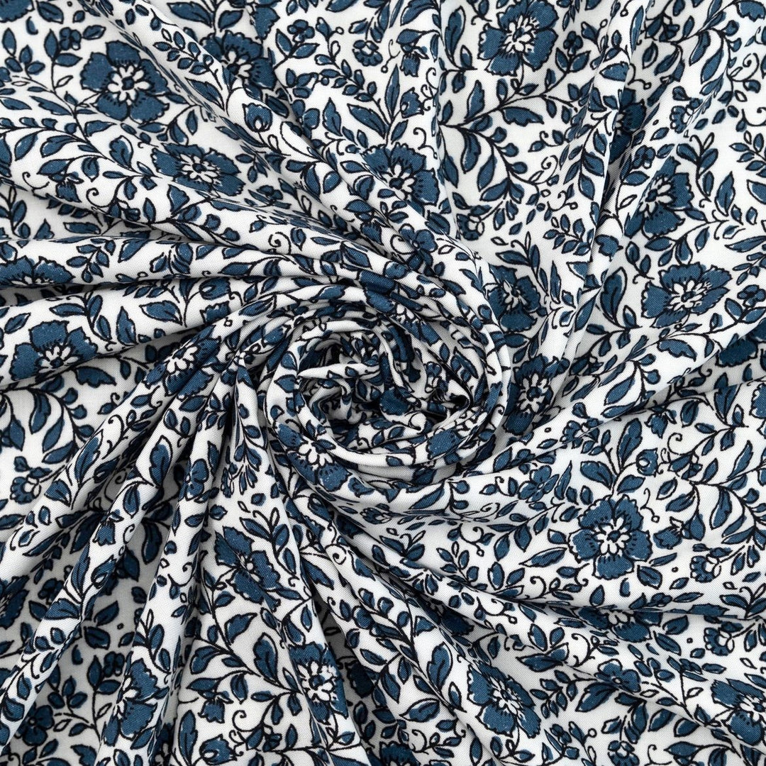 Rayon Challis Indigo Blossom Breeze fabric with indigo floral outline on white background, lightweight and soft drape textile for dresses, blouses, and skirts