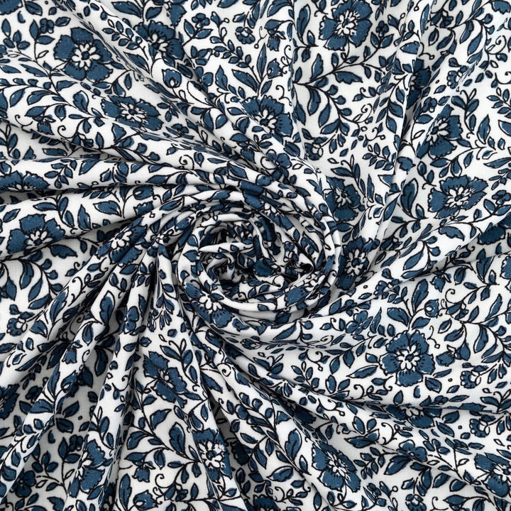Rayon Challis Indigo Blossom Breeze fabric with indigo floral outline on white background, lightweight and soft drape textile for dresses, blouses, and skirts