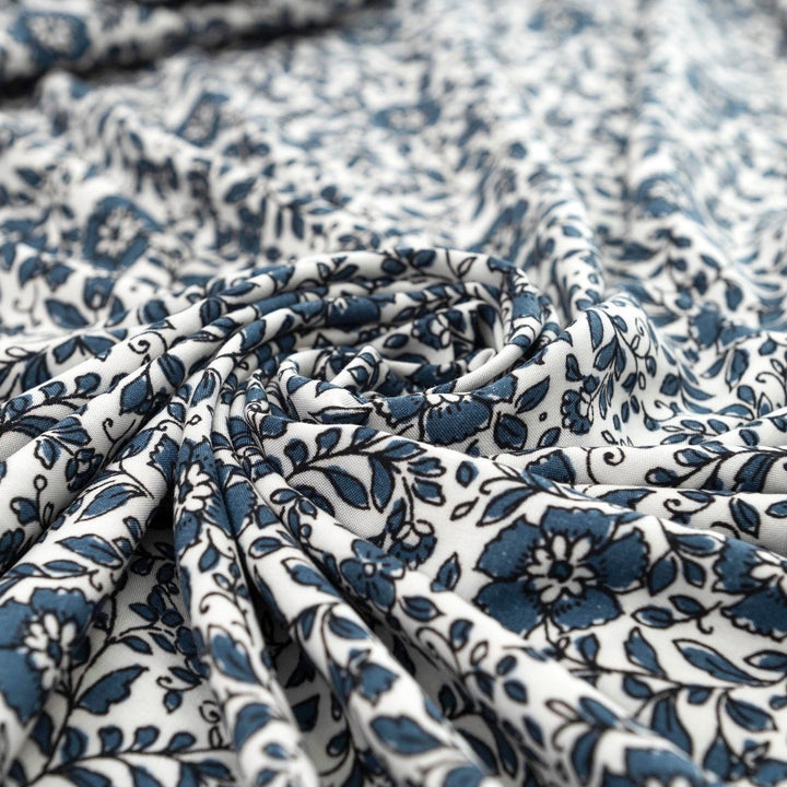 Rayon Challis Indigo Blossom Breeze fabric with indigo floral outline on white background, lightweight and soft drape textile for dresses, blouses, and skirts