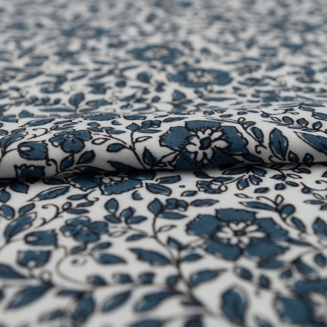 Rayon Challis Indigo Blossom Breeze fabric with indigo floral outline on white background, lightweight and soft drape textile for dresses, blouses, and skirts