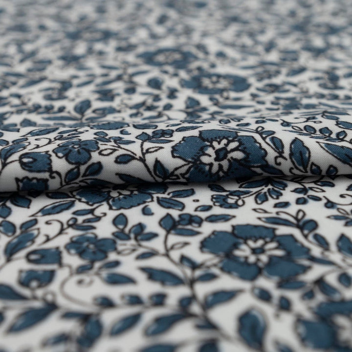 Rayon Challis Indigo Blossom Breeze fabric with indigo floral outline on white background, lightweight and soft drape textile for dresses, blouses, and skirts
