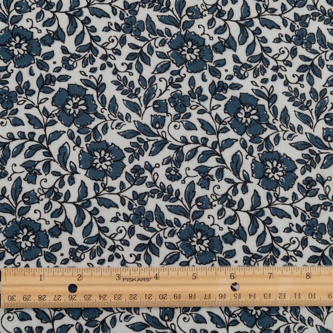 Rayon Challis Indigo Blossom Breeze fabric with indigo floral outline on white background, lightweight and soft drape textile for dresses, blouses, and skirts