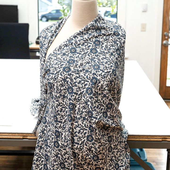 Rayon Challis Indigo Blossom Breeze fabric with indigo floral outline on white background, lightweight and soft drape textile for dresses, blouses, and skirts