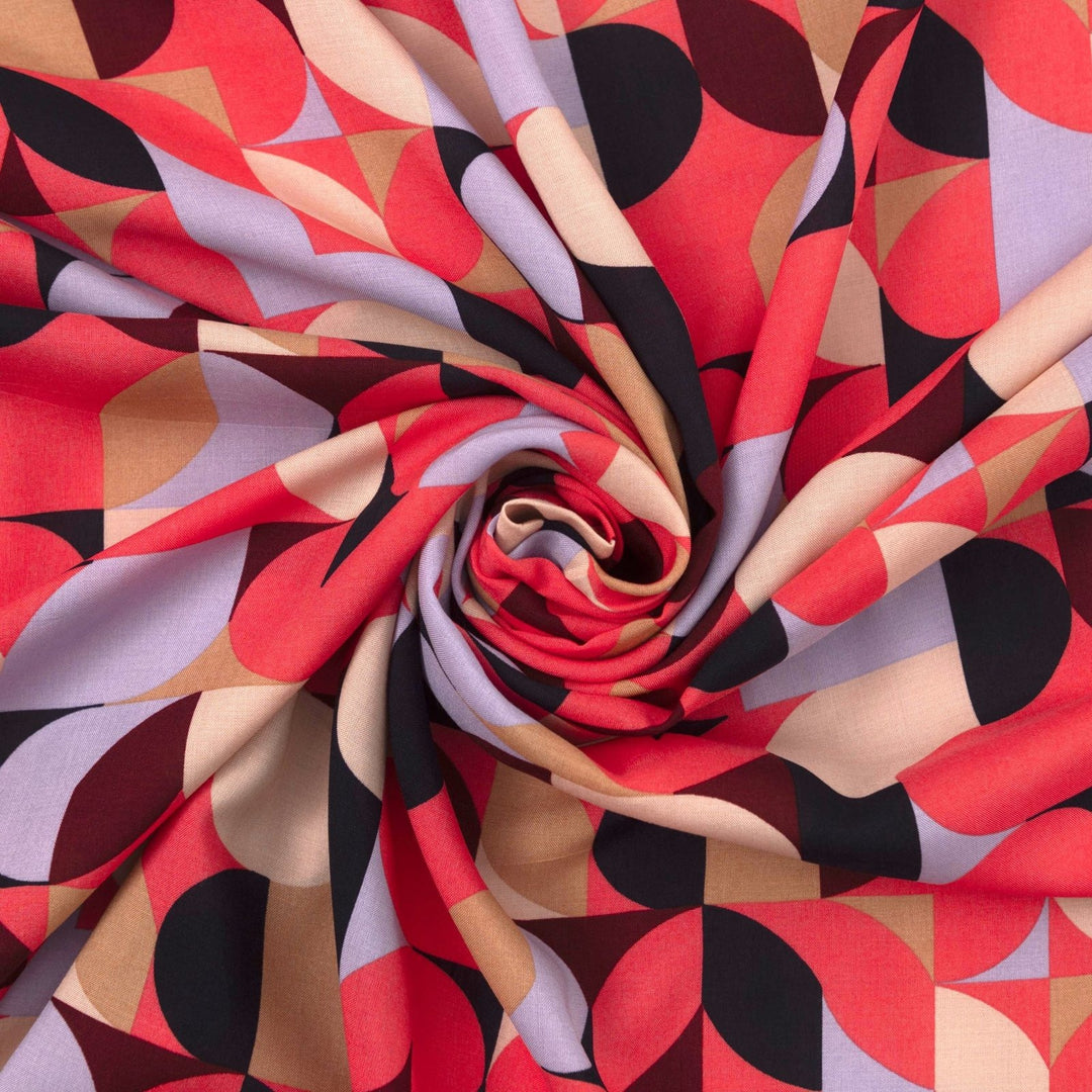 Viscose Challis "Kaleidoscope Bright" fabric featuring vibrant geometric shapes in pink, purple, black, and taupe, 58-inch width, perfect for dresses and summer garments