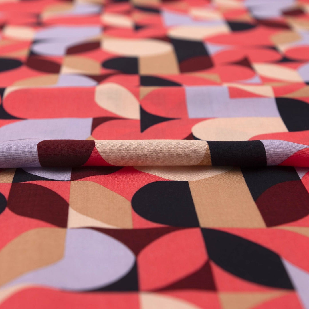 Viscose Challis "Kaleidoscope Bright" fabric featuring vibrant geometric shapes in pink, purple, black, and taupe, 58-inch width, perfect for dresses and summer garments