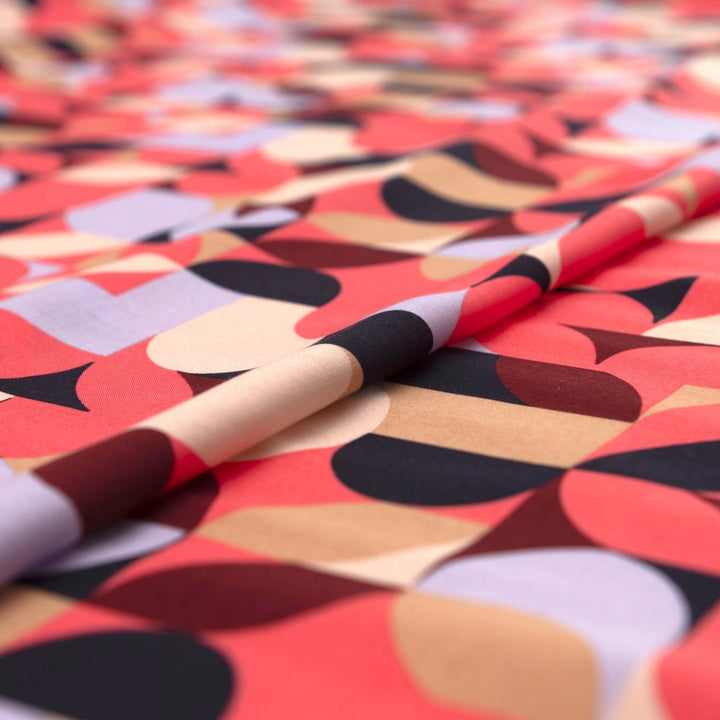 Viscose Challis "Kaleidoscope Bright" fabric featuring vibrant geometric shapes in pink, purple, black, and taupe, 58-inch width, perfect for dresses and summer garments