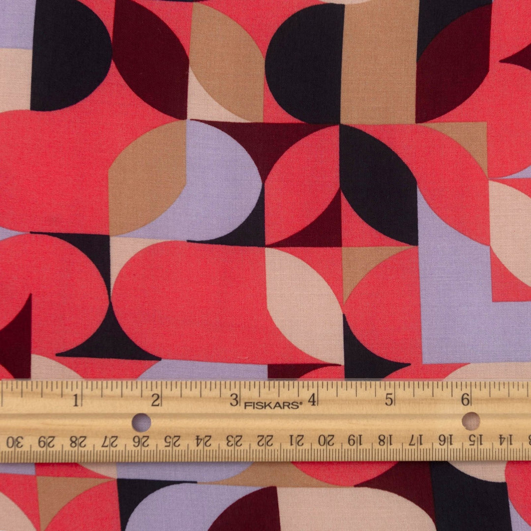 Viscose Challis "Kaleidoscope Bright" fabric featuring vibrant geometric shapes in pink, purple, black, and taupe, 58-inch width, perfect for dresses and summer garments