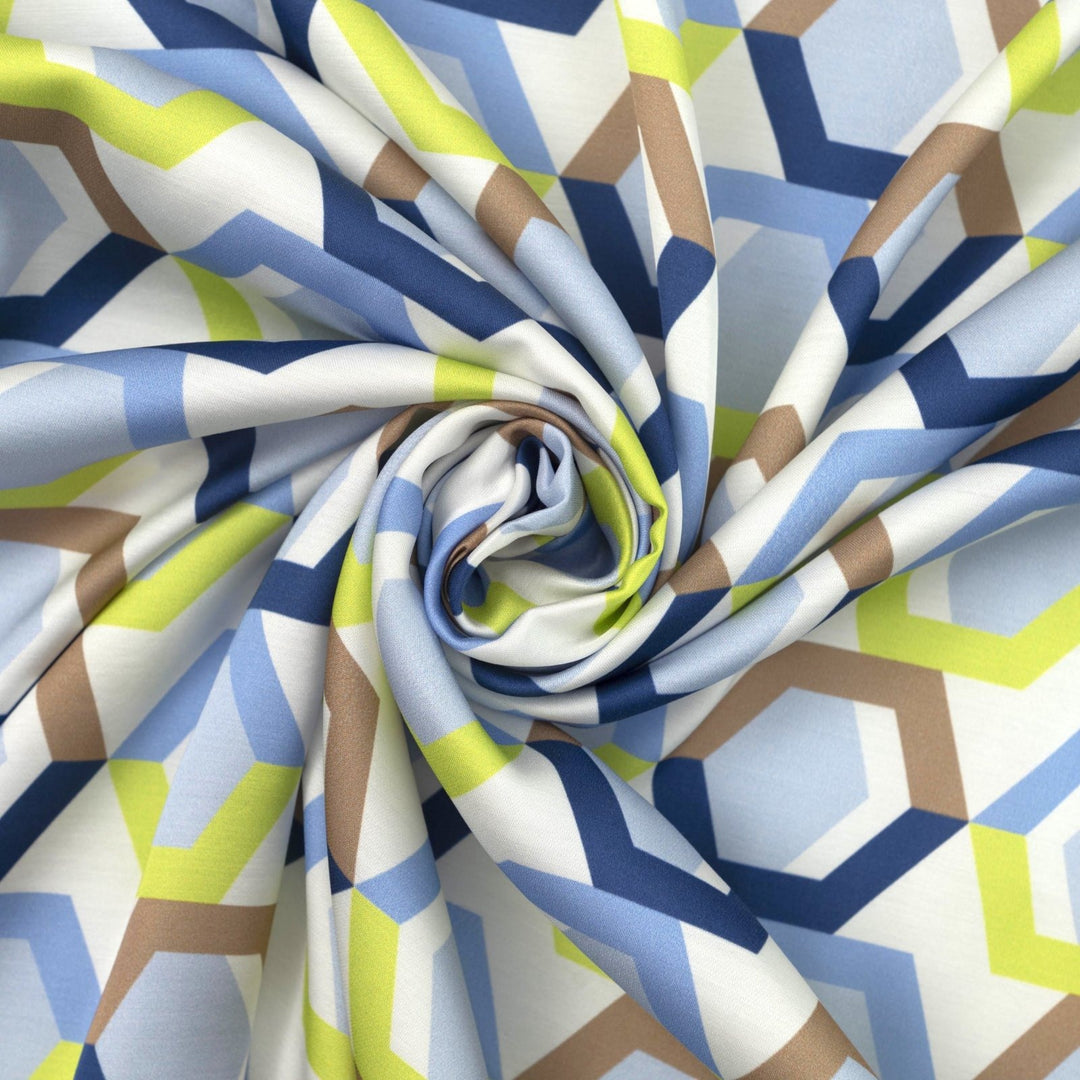 Viscose Sateen Prism Play fabric with geometric shapes in white, blue, and green, luxurious smooth drape and subtle sheen