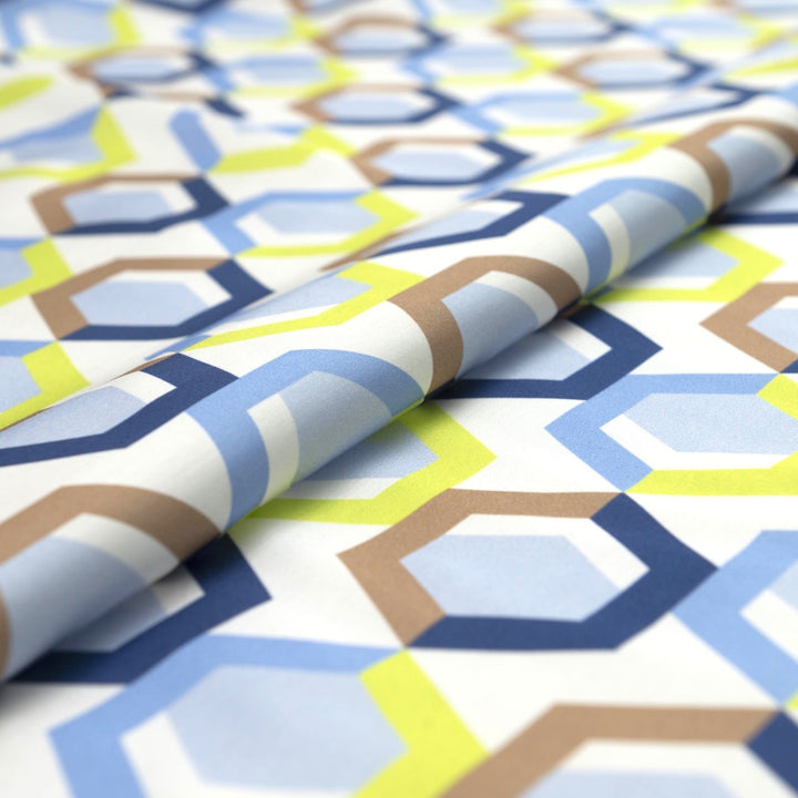 Viscose Sateen Prism Play fabric with geometric shapes in white, blue, and green, luxurious smooth drape and subtle sheen