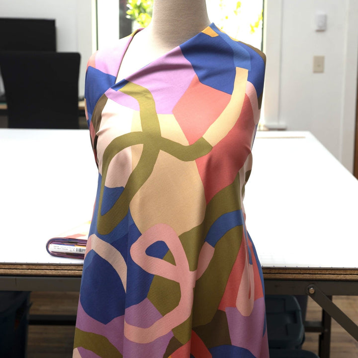Rosella Natural Flow viscose woven stretch fabric by Nerida Hansen in moss green, coral, cobalt, lilac and beige tones with satin finish