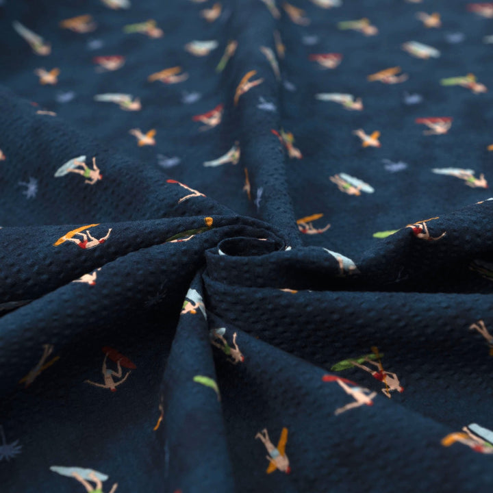 Cotton Seersucker Tiny Surfers – 100% cotton, 44 inches wide, navy seersucker with tiny surfer print, perfect for shirts, shorts, and sundresses