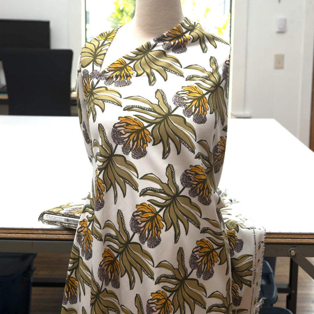 Ecovero Viscose Manifesto Ecru fabric by Nerida Hansen with botanical print in soft ecru and green, 58-inch wide, lightweight and drapey.